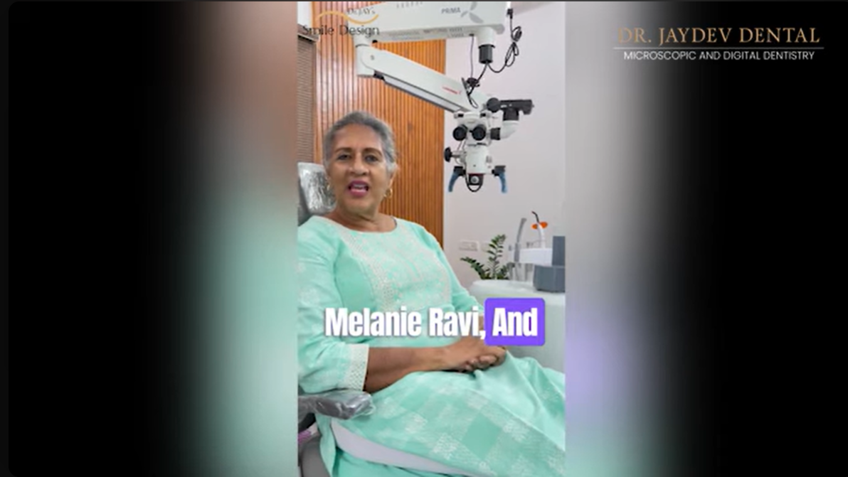 Portrait of Dr. Melanie Ravi in a mint-green outfit seated in a dental chair, with a dental microscope in the background; clinic branding visible in the corner.